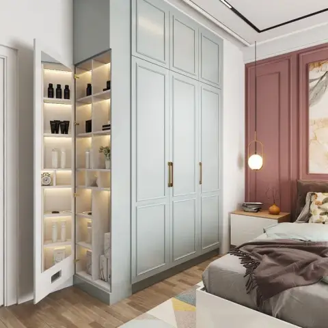 Pale sage shaker wardrobe with brass bar handles, its slim end cabinet swung open on LED-lit shelves of bottles and a clock