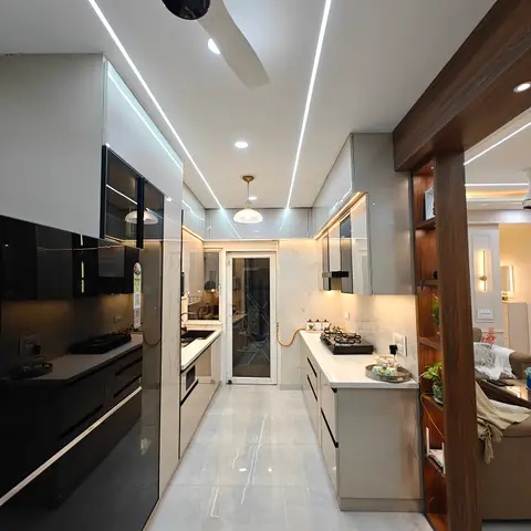Parallel modular kitchen with glossy black cabinets on one side and grey on the other