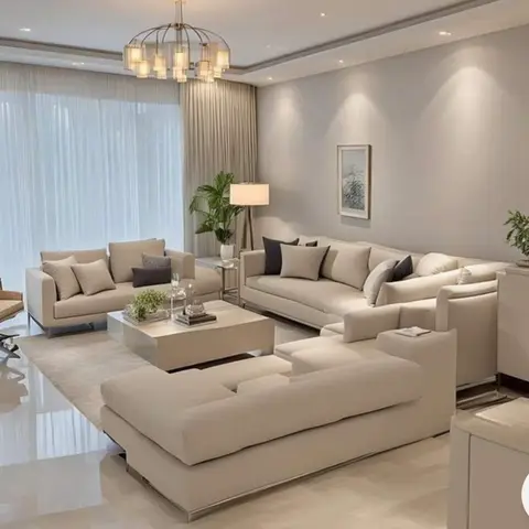 Phone-screenshot render (back-arrow overlay top left) of an all-beige living room with three low sofas and a chaise around a square ivory-and-chrome table