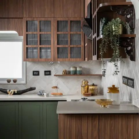 Photo of a kitchen mixing olive shaker base units with fluted walnut wall cabinets in reeded glass, a cream herringbone glazed dado