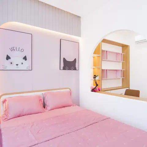 Pink kids' bedroom with framed cat and dog wall art above the bed and an arched pink open-shelf study nook beside it