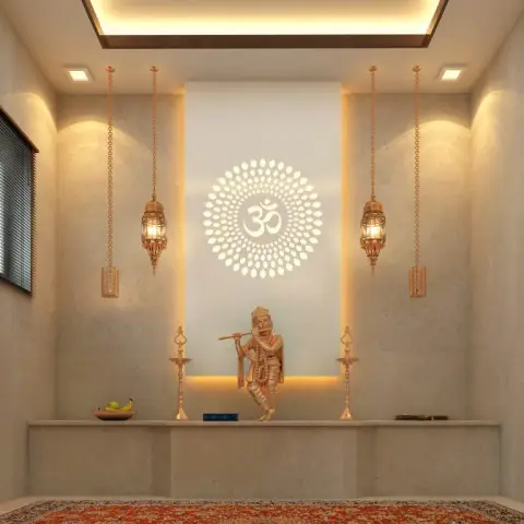 Pooja room with a backlit Om medallion wall panel, brass hanging lanterns, and a marble altar platform with a deity idol.
