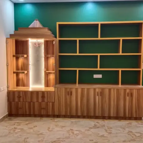Pooja unit with a temple-shaped wood cabinet and backlit niche standing beside an open wood-and-emerald-green display shelving unit.