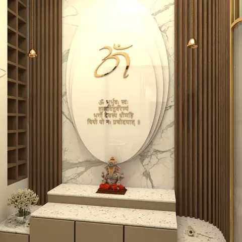 Pooja unit with a white marble backdrop panel inscribed with a gold Om symbol and Sanskrit verse, flanked by fluted wood pillars with hanging bells