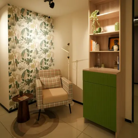 Reading corner with a plaid armchair on a round jute rug against tropical-leaf wallpaper