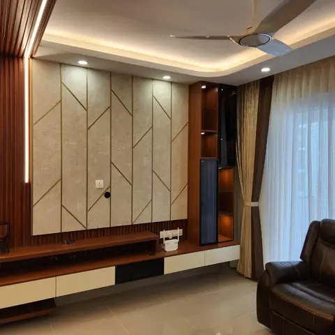 Real living room with a geometric brass-inlaid marble TV feature wall flanked by a fluted wood LED pilaster, a floating wood console