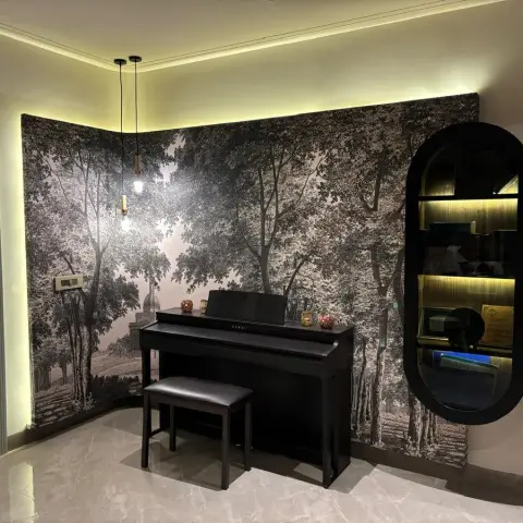 Real music corner with a black-and-white forest mural wallpaper wrapping the corner walls, a black digital piano and bench, an oval backlit display cabinet