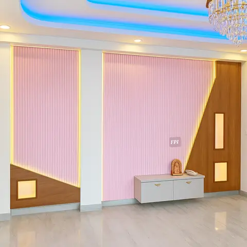 Real photo of a foyer feature wall with pink fluted panelling framed in gold LED trim, a blue-lit cove ceiling, a crystal chandelier