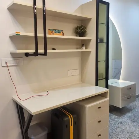 Real photo of a study desk nook with cream open shelving on black industrial pipe brackets, a quartz desktop with a drawer unit