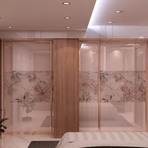 Render of a bedroom's mirrored sliding wardrobe wall — rose-gold framed panels carrying a printed blush rose-and-leaf band, split by a walnut pier