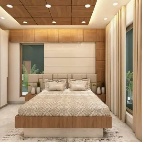 Render of a bedroom under a coffered wood-plank ceiling grid, with a veneer headboard wall of cream upholstered panels, a chunky timber platform bed