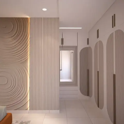 Render of a bedroom wardrobe wall: full-height cream shutters with arch-shaped fluted inlays and slim bronze handles