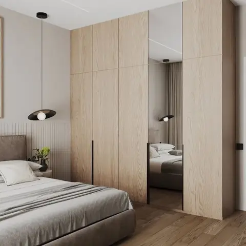Render of a bedroom with a light-oak wardrobe featuring a full-height mirror panel, twin pendant lights over the bed, wainscot wall panelling and wood flooring.