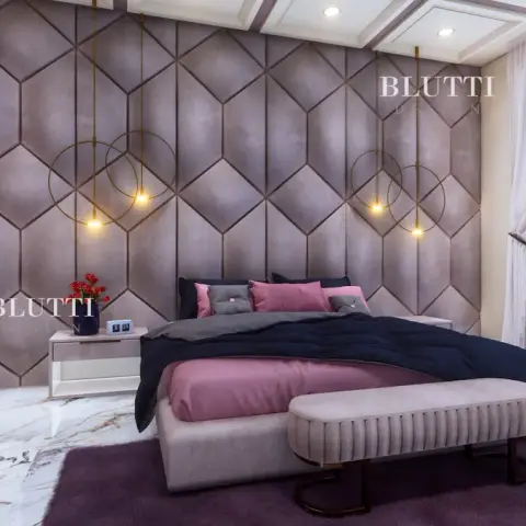 Render of a bedroom with a taupe suede hexagon-panelled headboard wall, brass ring pendants hung at each bedside
