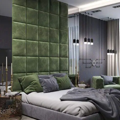 Render of a bedroom with a floor-to-ceiling emerald tufted-velvet headboard wall, a cluster of bare-bulb pendant lights and a dark geometric-patterned accent