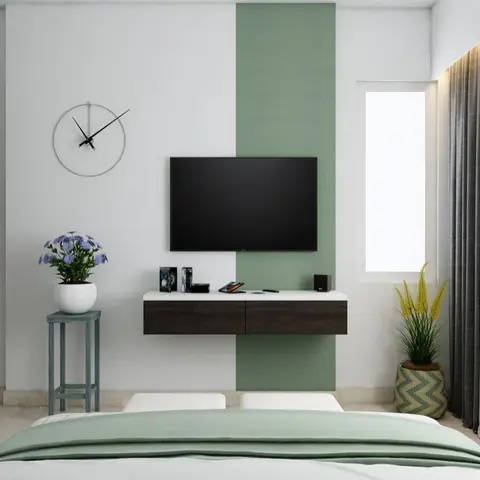 Render of a bedroom with a sage-green vertical accent stripe behind a wall-mounted TV, a floating dark-wood console with drawers, a round wall clock