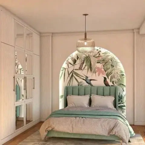 Render of a bedroom with a green fluted-panel bed set into an arched botanical mural niche, a rattan pendant light