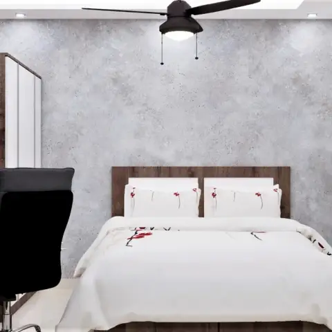 Render of a compact study-cum-bedroom with a wood study desk and open shelving beside the bed, set against a raw concrete-textured accent wall