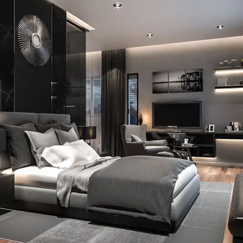 Render of a dark master bedroom with a black marble feature wall and starburst mirror behind the bed, facing a wall-mounted TV, gallery wall and armchair.