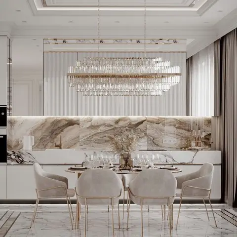 Render of a dining table of six ivory-and-brass tub chairs set right against the kitchen run, under a long two-tier crystal bar chandelier