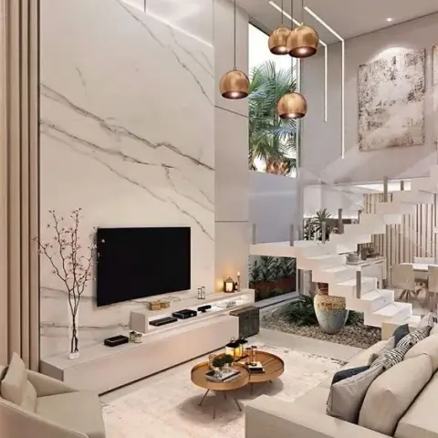 Render of a double-height living room where a full-height white marble slab wall carries the TV above a floating ivory console