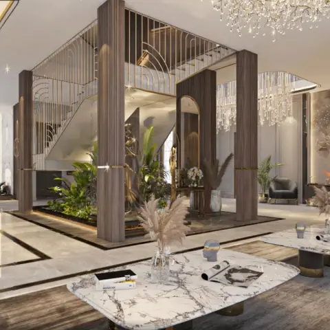 Render of a double-height villa hall where fluted dark-wood columns frame a planted indoor garden under a gold-balustraded staircase