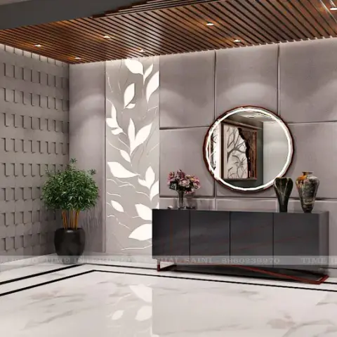 Render of a foyer where two backlit white leaf-cut jaali panels bracket a grid of grey suede cushion panels, a round backlit mirror over a dark console
