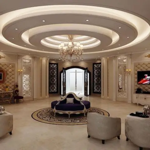 Render of a grand living room with a circular tiered POP ceiling and crystal chandelier, classical tufted wall panelling