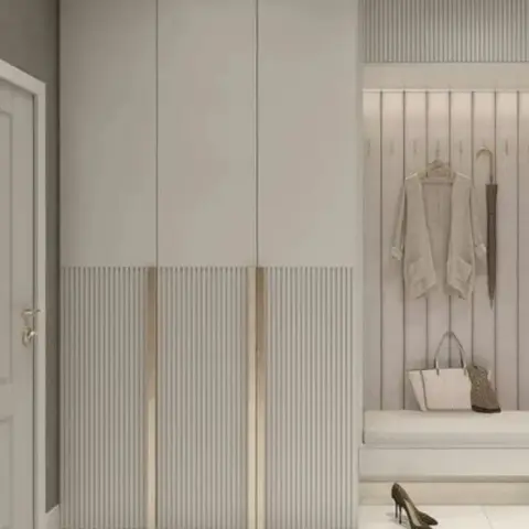 Render of a greige entrance foyer: a full-height shoe cabinet with fluted lower shutters and brass edge pulls