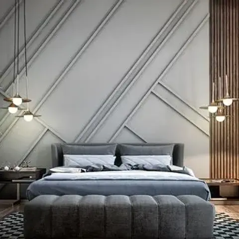 Render of a grey upholstered bed set against a headboard wall of diagonal criss-cross mouldings, with a brass three-drop pendant on one side