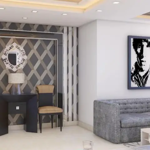 Render of a living area where a dark console with two chairs and a carved mirror sits against a grey-and-beige diamond faceted wall