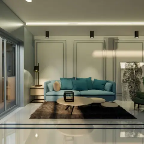 Render of a living room at night with a teal sofa against a wall of slim recessed mouldings, lit by a row of black surface-mounted cylinder spots