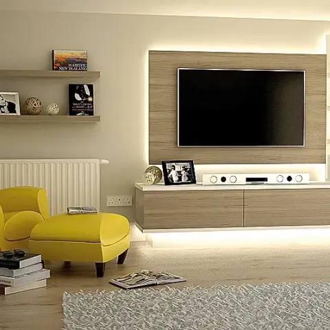 Render of a living room where a pale oak TV panel is halo-lit against a cream wall over a long floating console with a lit recess at the floor