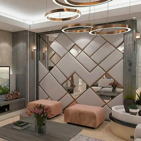 Render of a living room whose feature wall is a diamond lattice of beige upholstered tiles and mirror set in rose-gold trim
