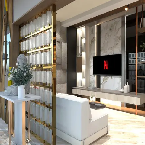 Render of a living room with a brass-framed glass jaali screen dividing the entry from a bookmatched marble TV feature wall and floating console.