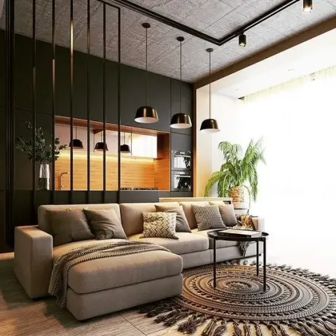 Render of a living room with a bare board-marked concrete soffit and black surface track, a beige L-sectional with a chaise facing a round fringed jute rug