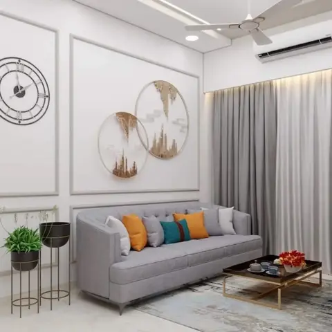 Render of a living room with a channel-tufted grey sofa in colourful cushions, wall-panel moulding topped by circular gold wall art