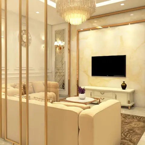 Render of a living room with a book-matched gold-veined marble TV wall in a brass frame, a crystal chandelier, a beige tufted sofa