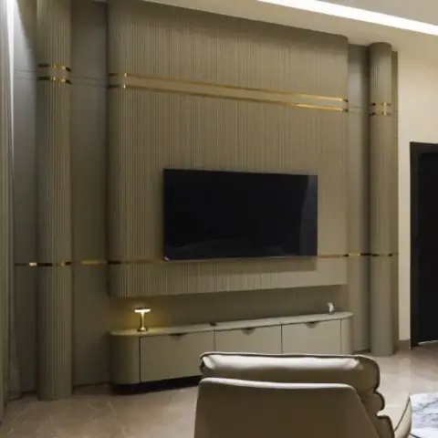 Render of a living room with a fluted taupe TV feature wall banded in gold trim, a curved cove ceiling, a rounded console