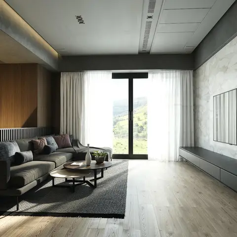 Render of a living room with a dark grey sectional sofa and nested round coffee tables facing a marble slab TV wall, glass doors opening onto a hillside view.