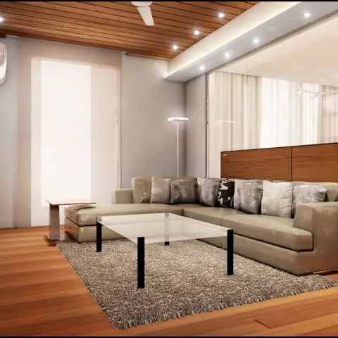 Render of a living room with a wood-slat ceiling, built-in shelving and TV unit, and an olive leather sectional sofa around a glass coffee table.