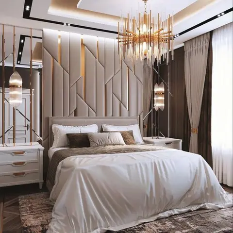 Render of a luxury bedroom with a geometric gold-trimmed upholstered headboard wall, a large crystal chandelier, and layered beige and brown curtains.