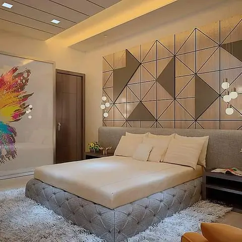 Render of a master bedroom where a grey tufted platform bed sits against a triangular wood-and-metal grid panelled wall