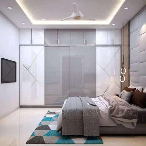 Render of a master bedroom with a grey upholstered panel headboard wall, mirrored sliding wardrobe doors, a cove-lit POP ceiling, and a teal geometric rug.