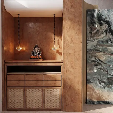 Render of a moody pooja alcove with textured bronze walls, hanging diya-style pendant lights over a brass Ganesh idol