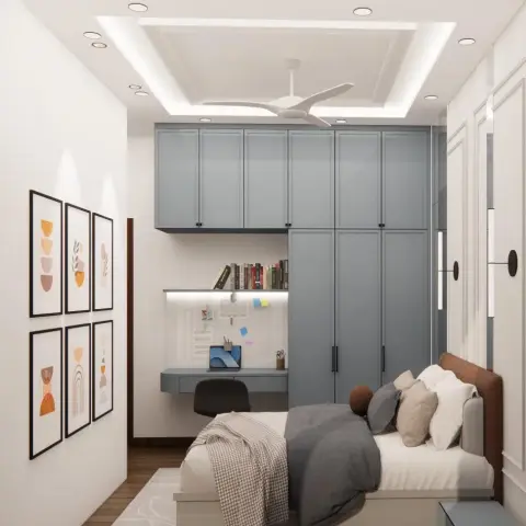 Render of a narrow bedroom where a dusty-blue shaker wardrobe wall wraps around a wall-hung study desk with a pinboard and lit book ledge