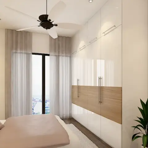 Render of a narrow bedroom where a white upholstered headboard sits against a gold-textured accent wall under a dark wooden fan