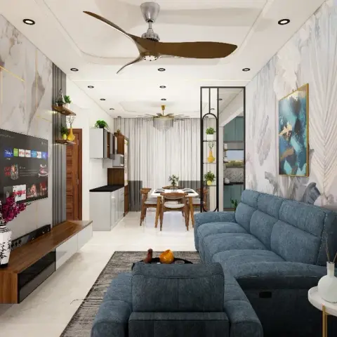 Render of a narrow living room where a blue fabric recliner set on a grey rug faces a Statuario-look TV panel inlaid with brass lines over a floating walnut