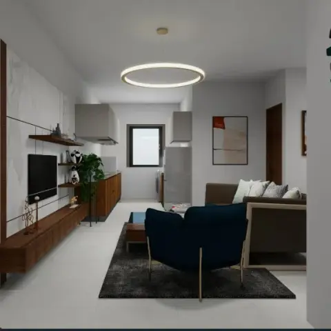 Render of a narrow open-plan living room with a navy tub chair on a charcoal rug, a walnut floating TV console against a marble-look panel wall and the kitchen