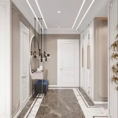 Render of a neo-classical entry hall: greige panel-moulded walls, a slim console under a round black-rimmed mirror with a cluster of black-and-brass pendant
